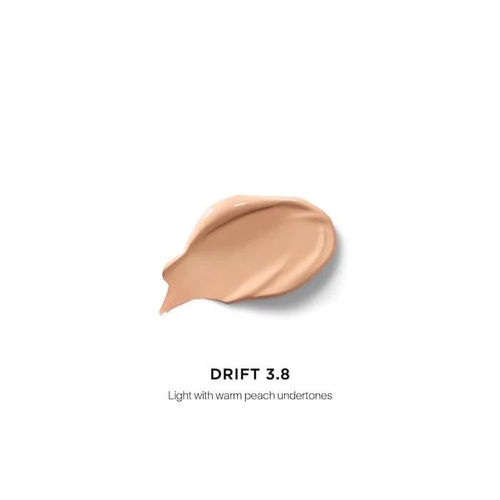 The Hourglass Vanish Airbrush Concealer features a distinctive metallic bronze cap with a slanted geometric design and a soft doe-foot applicator