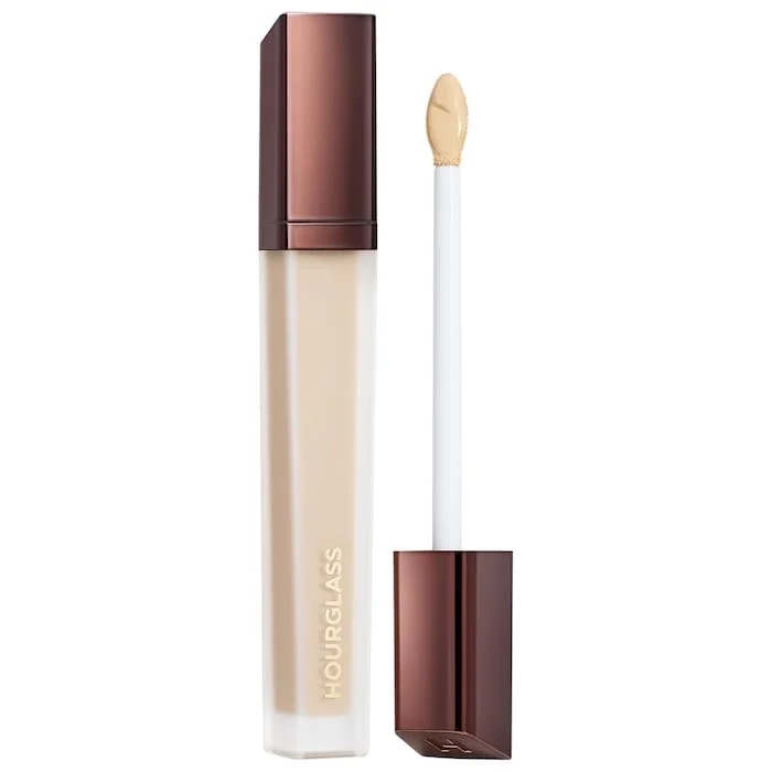 The Hourglass Vanish Airbrush Concealer features a distinctive metallic bronze cap with a slanted geometric design and a soft doe-foot applicator