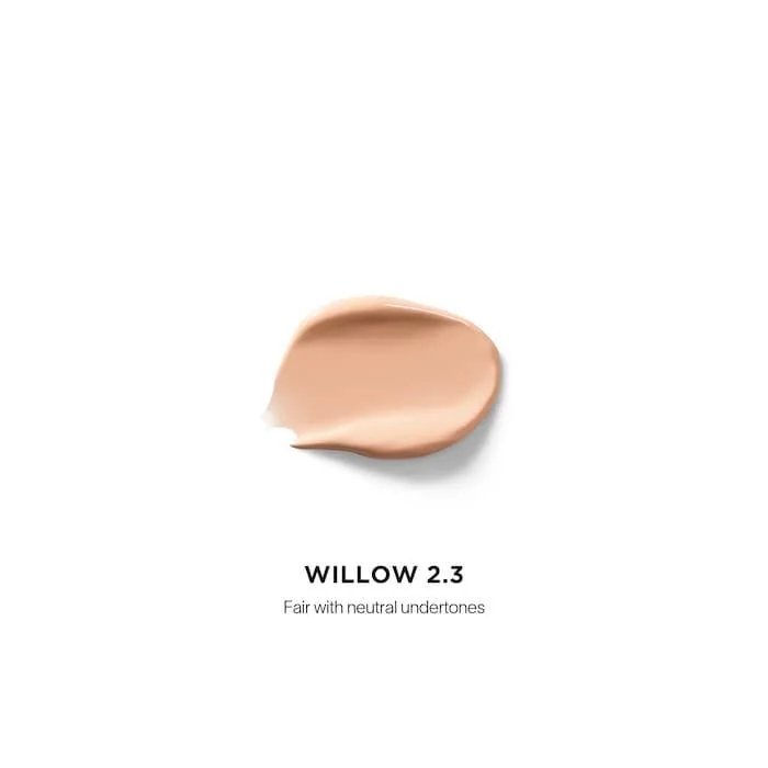 The Hourglass Vanish Airbrush Concealer features a distinctive metallic bronze cap with a slanted geometric design and a soft doe-foot applicator