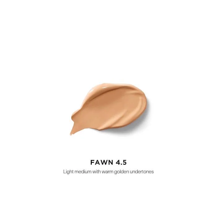 The Hourglass Vanish Airbrush Concealer features a distinctive metallic bronze cap with a slanted geometric design and a soft doe-foot applicator