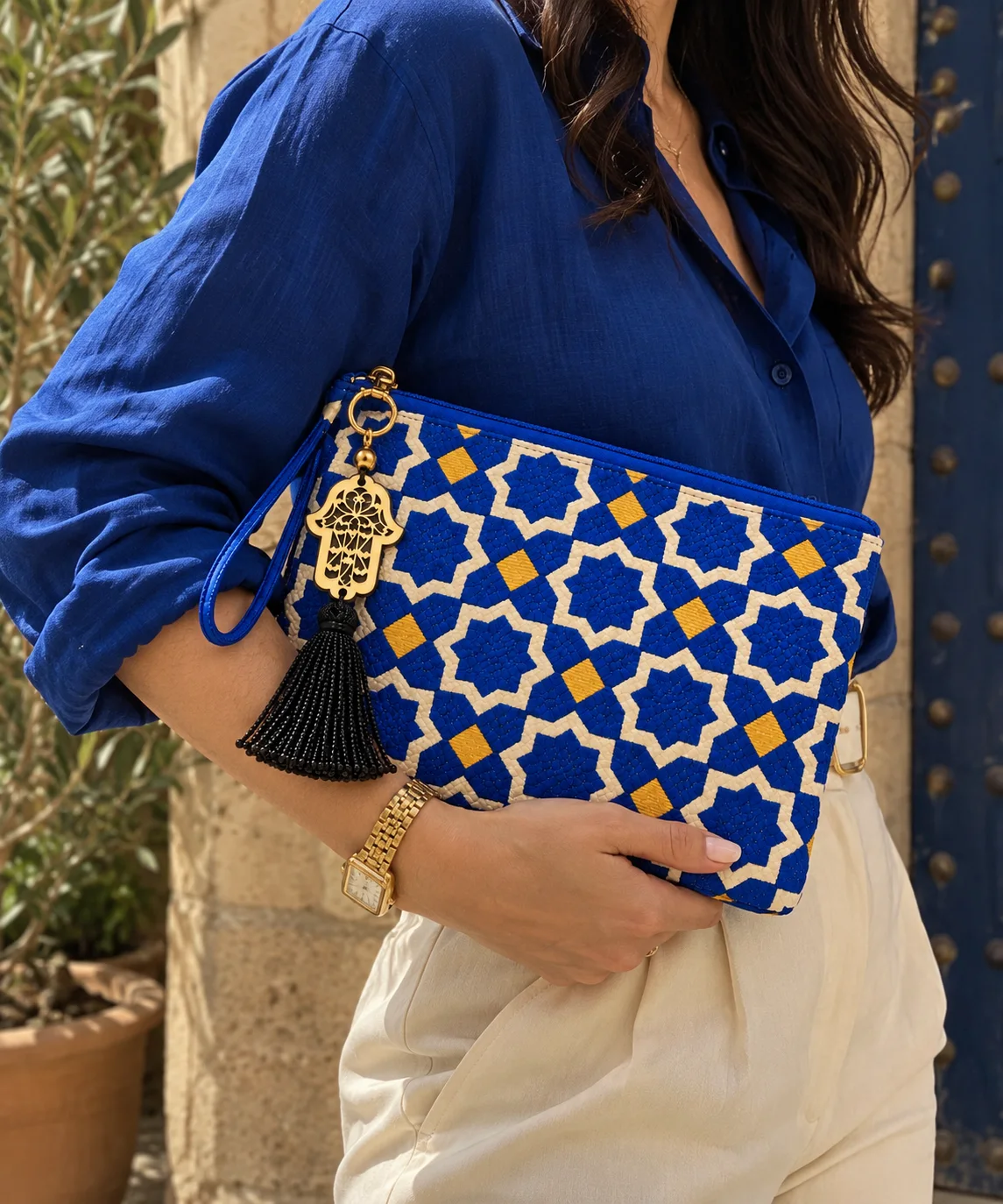 Pochette grande blu indossata con un completo mediterraneo